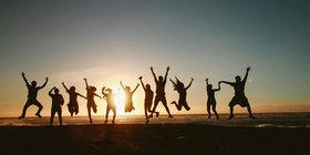 A group of people jumping in the air together