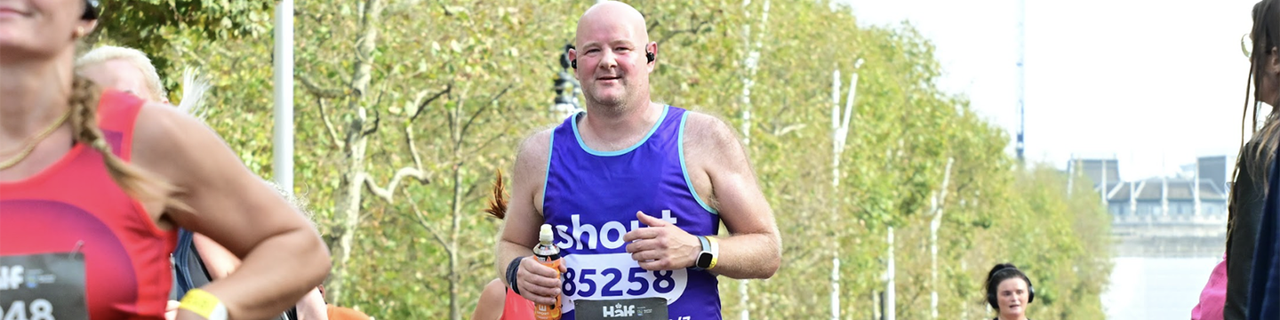 Adrian running Royal Parks Half in Shout vest.png