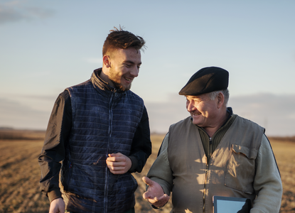 two farmers in a golden field