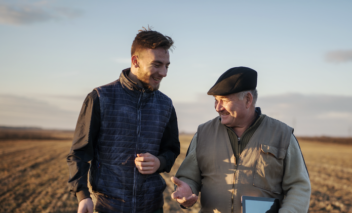 two farmers in a golden field