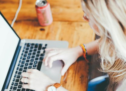 woman typing keyboard laptop