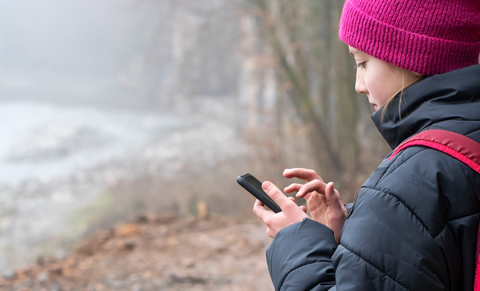 young-girl-winter-outdoors-texting.png