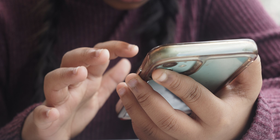 Child's hands holding smart phone