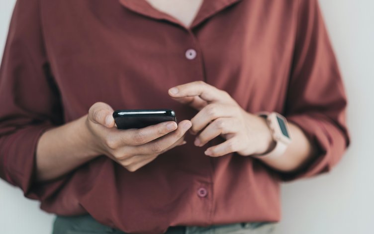 A hand holding a phone